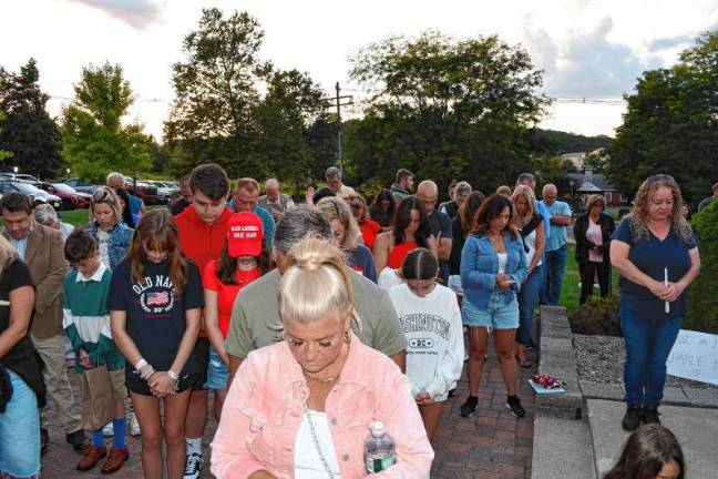 Action on flags attracts criticism Residents bow their heads during a vigil Sunday, Sept. 14 in Sparta for Charlie Kirk, who was shot and killed Wednesday, Sept. 10 while speaking on a college campus in Utah. (Photo by Maria Kovic)