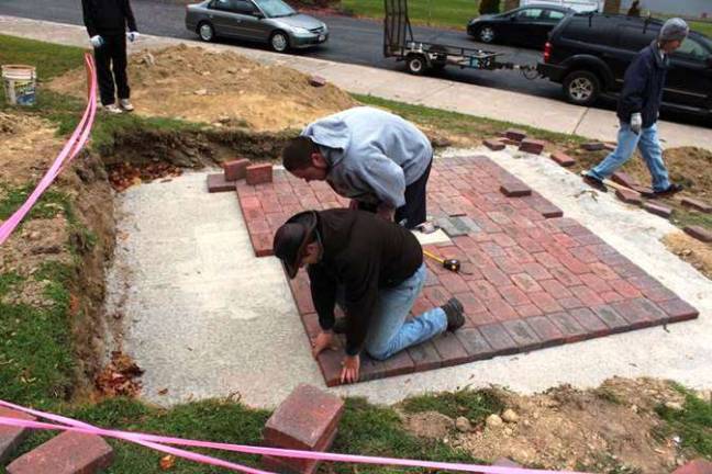 Eagle Scout honors Sussex County veterans Schuyler Caffrey, 18, is shown laying bricks at High Point Regional High School as part of his Eagle Scout project.