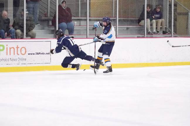 Roxbury defeats Sparta-Jefferson A Roxbury Gael begins to fall while pursuing the puck and clashing with a Sparta-Jefferson United player.