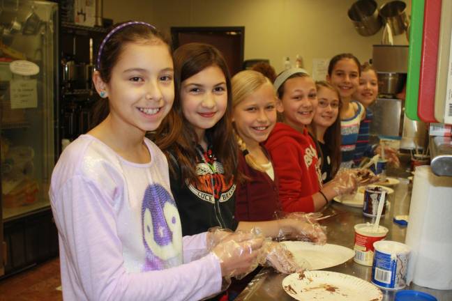 Family Volunteer Day brings out community Helen Morgan fifth graders bake cookies at Family Volunteer Day. Pictured left to right Jollie Dottinger, Athena Battaglia, Paige Mongon, Tristen Pallito, Nicole Strouse, Katie Groome and Emma Muth.