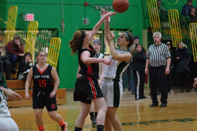 A Hackettstown Tiger knocks the ball away from a Mustang.