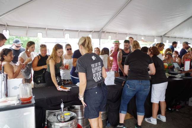 The sangria and beer tent had a constant stream of visitors with some standing in the rain while they waited for service.