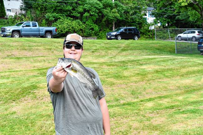 Photos: Wantage fishing contest <b>Kevin Schmitz of Wantage holds a bass he caught in the contest.</b>
