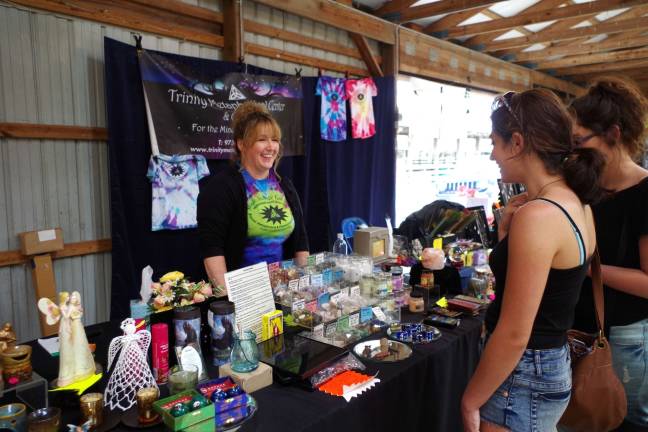 Jacqui Geary of the Hamburg/Hardyston Trinity Metaphysical Center answers questions about various stones, ointments and tarot cards that she had for sale during the company&#x2019;s annual festival held at the county fairgrounds.
