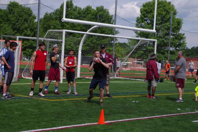 Fourteen-year-old John Kreusch about to throw the ball in the pass contest.