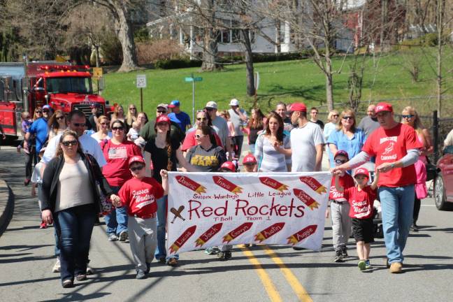 The Red Rockets march in the Sussex Wantage Little League Opening Day parade and banner contest.