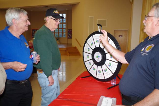 At the far right, Walt Hazelman kept the Wheel of Fortune spinning throughout the evening.