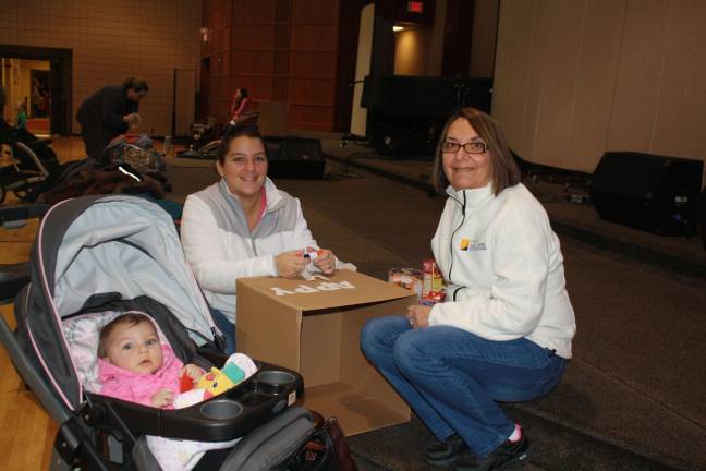 Family Volunteer Day brings out community Baby Samantha Barret with her mother Stacy Barret and grandmother Angela Altar.