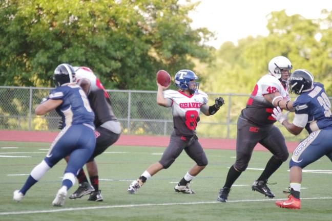 Silk City Sharks quarterback Santiago in the midst of throwing the ball in the first half.
