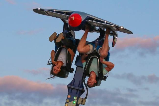 A carefree couple enjoys their ride, upside down, at the 2019 Sussex County fair.