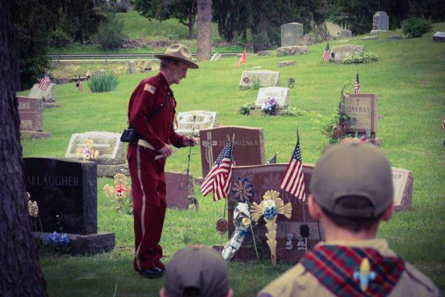 VFW, Boy Scouts place flags on veterans graves