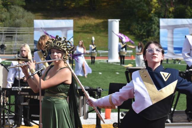 This flutist wears a Medusa headpiece.