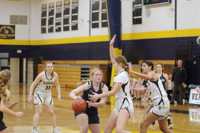 A Vernon player handles the ball as the Wallkill Valley Rangers defend.