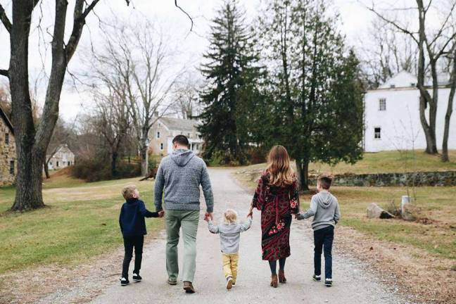 Reilly's main impetus for exploring essential oils was to better her health and that of her family. Here she is strolling with her husband and their three sons.