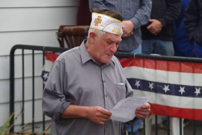 Post Commander Jim Davis of Highland Lakes is shown reading from The Code of Conduct for Members of the United State Armed Forces during Wednesday&#xfe;&#xc4;&#xf4;s solemn ceremony commemorating Veterans Day at the Wallkill Valley VFW. Memorial Post 8441 of the Veterans of Foreign Wars.