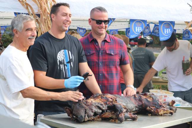 glenwood oktoberfest Vernon Police Officer Kenneth Kuzicki (Center) poses with what has become a yearly tradition in Glenwood Estates and Colonial Oaks, the roast pig of Oktoberfest.