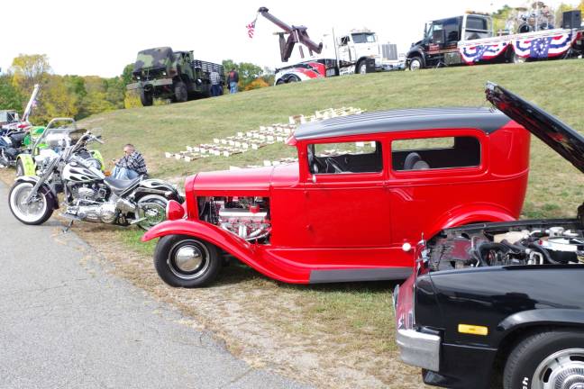 Vintage cars, hotrods, and motorcycles lined the access road.