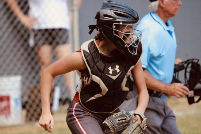 Catcher Daphne Matthews, a freshman, prepares to make a long throw to second base.