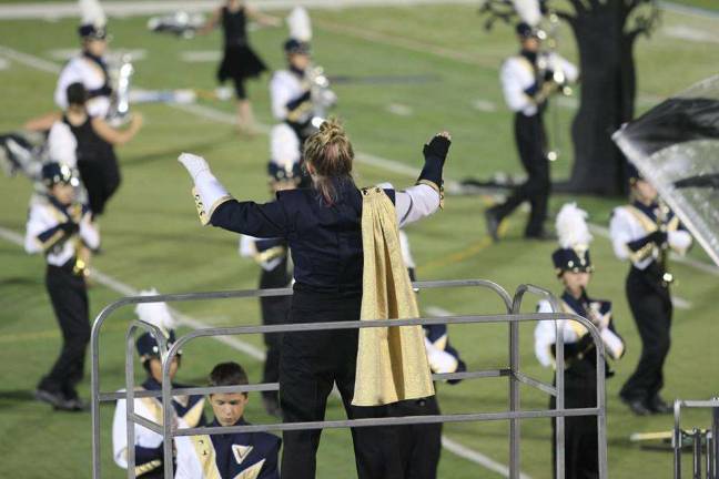 Drum Majors march to a winning beat Conducting the band on the football field.