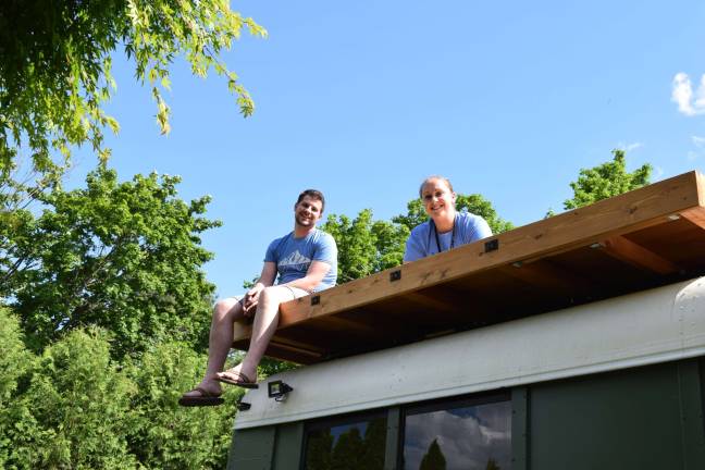 Photo by Erika Norton Lot of friends have helped Michael Fuehrer build his home, including Kerris Ackley and Coriann Grunstra, both sitting on top of the bus' deck.