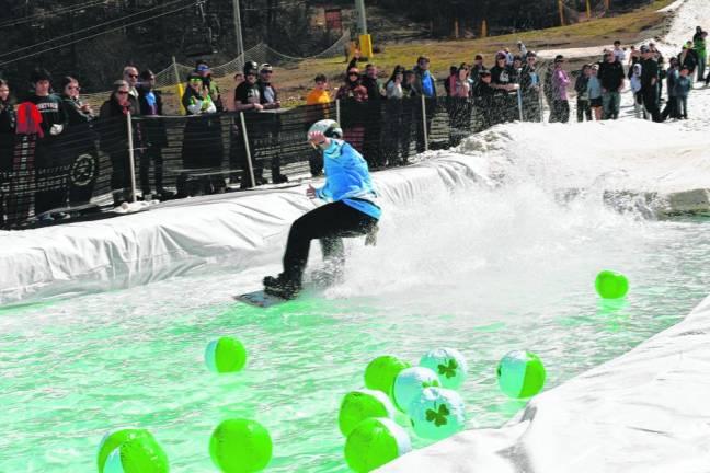 Competitors ski onto a man-made pond at the end of the slope in the South Base Area. (Photos by Maria Kovic)