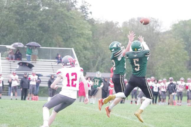 Newton leads division Two Sussex Tech defenders leap in an attempt to intercept the ball in the first half.