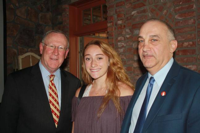 Responders support group presents scholarships Tom Ryan, chairman of the Scholarship Committee for The 200 Club and Tony Torre flanke Kittatiny senior and scholarship winner Emma Frtisch.