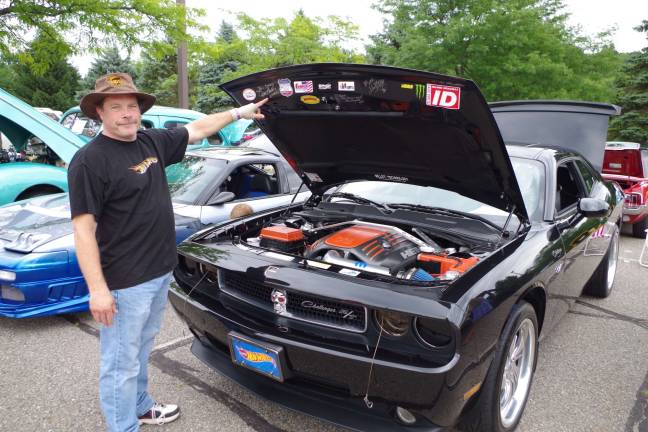 Bllair Debois of West Milford, New Jersey points to some of the celebrity autographs on his customized 2010 Dodge Challenger R/T.