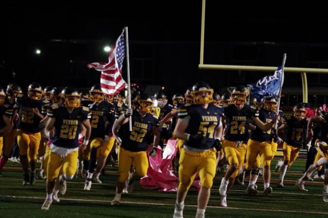 The Vernon Vikings run onto the field before the start of the game against Sussex Tech on Friday, Oct. 20.