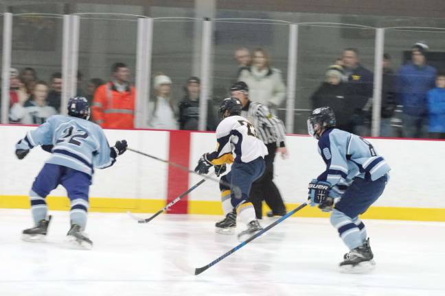 Vernon's Patrick Graham steers the puck between two West Morris Central players. Graham scored two goals.