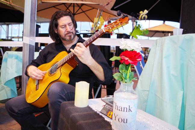 Guitarist George Orlando playing tunes for guests.