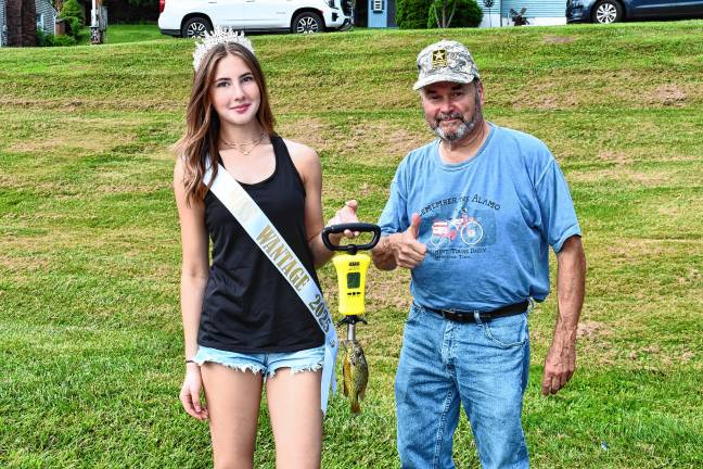 Photos: Wantage fishing contest <b>Miss Wantage Gianna Kimkowski holds a device to determine the size of a fish. At right is Warren Wisse, president of the Wantage Recreation Committee.</b>