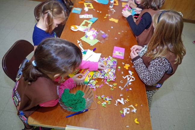 Girls work at the crafts table.