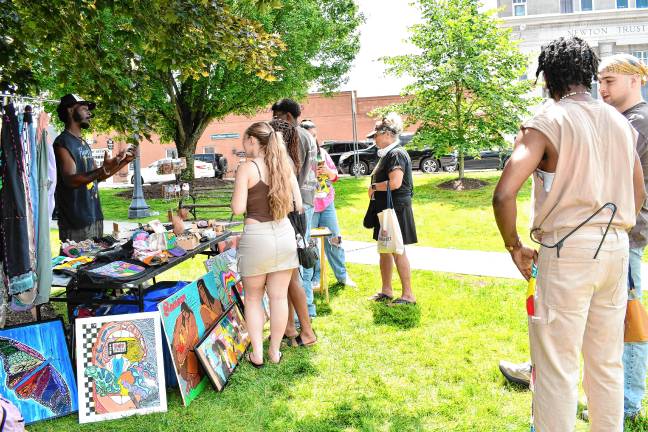 Juneteenth: Celebrating freedom and unity People shop at the fifth annual Juneteenth celebration, hosted by the H3AL Network, on June 21 at the Newton Green. (Photo by Maria Kovic)