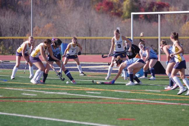 Sparta and Vernon players focus on the ball near the goal post.