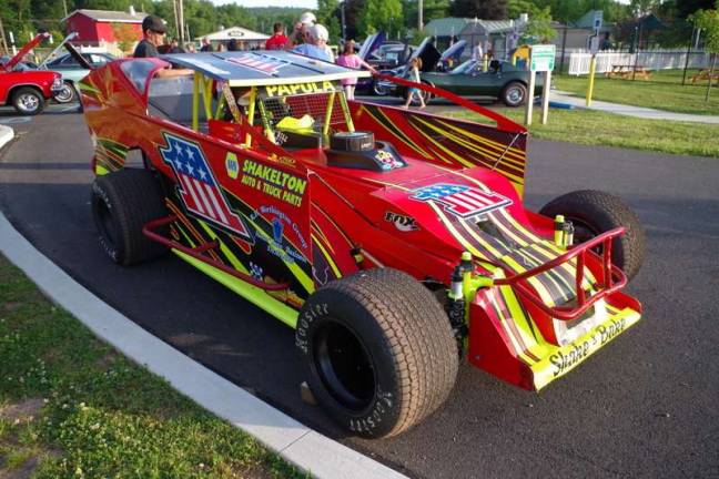 Bill Papula's race car on display, covered with sponsor logos: Papula (behind the car wearing a black hat and shades) is an elementary school teacher who lives in Matamoras. He's also been a race car driver since 1989. (Photo by George Leroy Hunter)