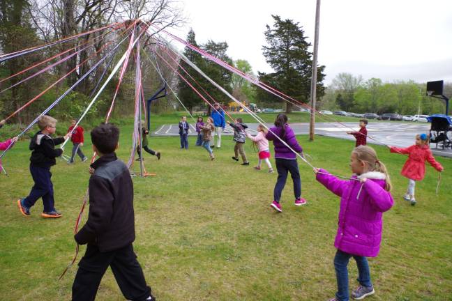 Students at Walnut Ridge Primary School had a taste of May Day and the chance to try a Maypole Dance on Monday. As the students in the outer circle walked in a clockwise direction the inner circle walked counterclockwise.