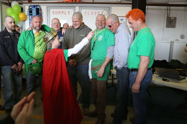 Residents go bald for charity King Ryan Klein crowning the Knights of the bald table at St. Baldericks. All are volunteers for seven or more years (1)