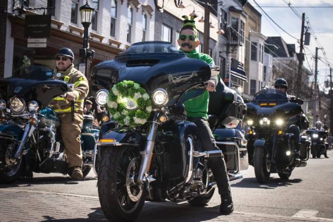 Members of Red Knights Chapter 13, a motorcycle club for firefighters and their families, ride in the parade.