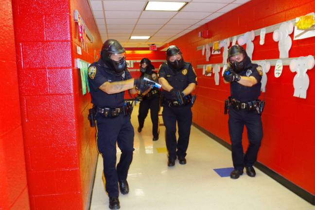 Being prepared Photo by Chris Wyman During an active shooter drill, four Vernon police officers go through Walnut Ridge Elementary School looking for three shooters. The drill took place in august.