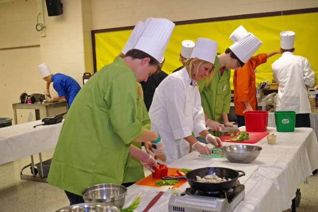 The Taste Buds team is shown preparing their meals. Team members included Michael Agosta, Krystoff Porter, Jewel Vanderhee, Shane Rodriquez, and Teacher Chef Barbara O'Keefe.