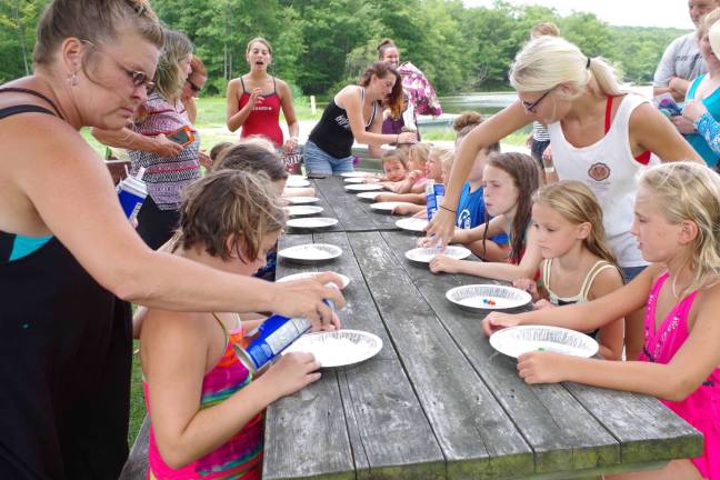 At left, Barry Lakes Recreation Director Tracy Mulvaney is shown covering M&amp;Ms with whipped cream for the bobbing for M&amp;Ms contest.