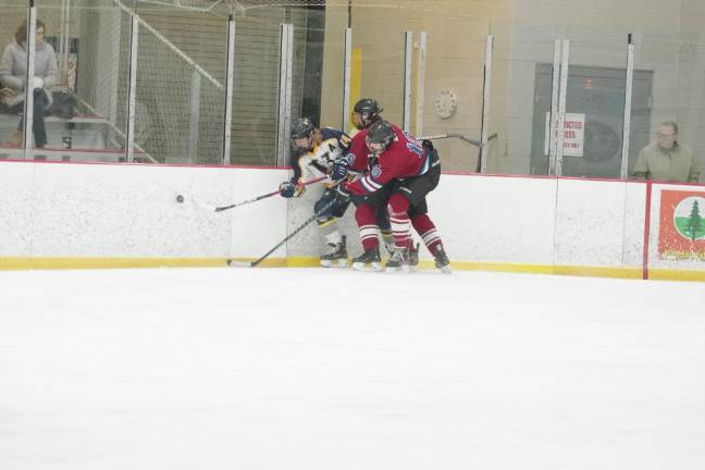Vikings advance to H/W/S semis Hockey players battle for control of the puck.