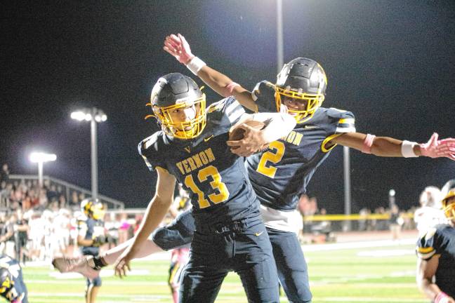 Football roundup: Vikings slay Wildcats, 35-28 <b>In the third quarter, Vernon quarterback Nathaniel Kimkowski (13) celebrates a touchdown with teammate Sam Simone. Kimkowski made three touchdowns in the game.</b>