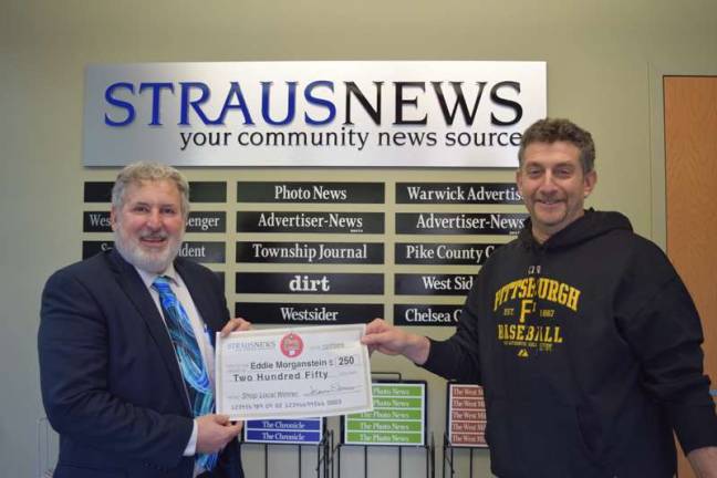 Frank Curio, the director of sales and marketing for Straus Newspapers Inc., presents a check for $250 to Eddie Morgentstein, the most recent winner of the Straus News Shop Local Sweepstakes. He entered the contest by submitting his receipt from Okaeri Sushi and Hibachi in Monroe.