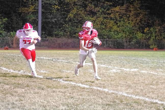 Wildcats claw Patriots, 35-6 <b>High Point ball carrier Slade Muller is chased by Lenape Valley defensive lineman Will Doyle in the first half.</b>
