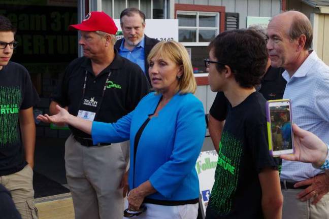 Lieutenant Governor Kim Guadagno talks with members of the Newton High School robotics team during a visit at the Sussex County Fair. At far right Congressman Scott Garrett (5th District of N.J.) also attended. Lieutenant Governor of New Jersey, Kim Guadagno met with the Newton High School robotics team at the Sussex County Fair on Monday, August 8th 2016. Ms Guadagno interacted with the team members as they spoke with her about science and engineering and demonstrated several machines built by the team.