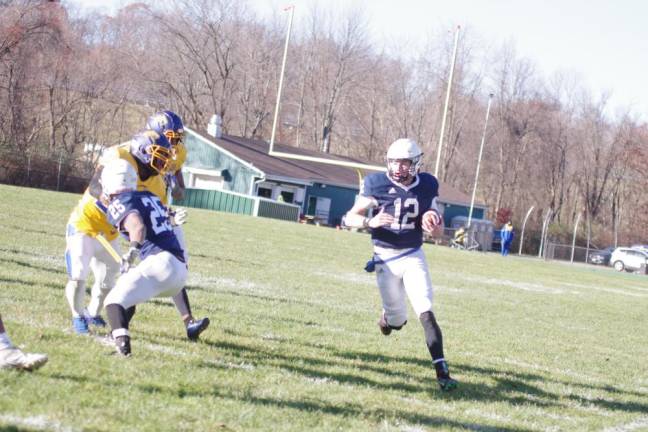 SCCC quarterback James Laubstein runs with the ball in the first half. He threw for a total of 328 yards, including one touchdown, and he rushed for two more touchdowns.