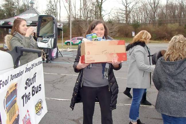 Stuff the Bus was under way at First Hope Bank on Friday and other weekend locations with many happy volunteers.