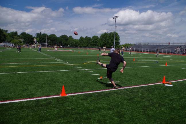 A contestant kicks the ball in the kick contest.